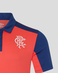 Close up of Rangers FC Pro Training polo chest with white crest on cayenne red fabric and blue collar.