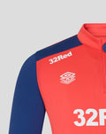Close up of the Rangers FC training top showing the 32Red sponsor and Umbro Training logo on cayenne red chest with navy sleeves.
