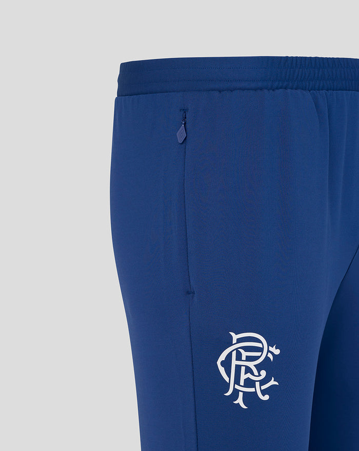 Twilight blue Rangers FC training pants close up showing back zip pocket and white club crest on the thigh