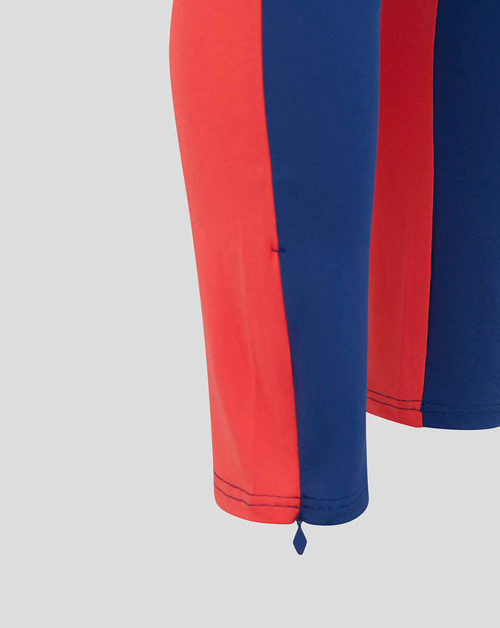 Lower leg detail of twilight blue Rangers training pants with red side panels and ankle zipper