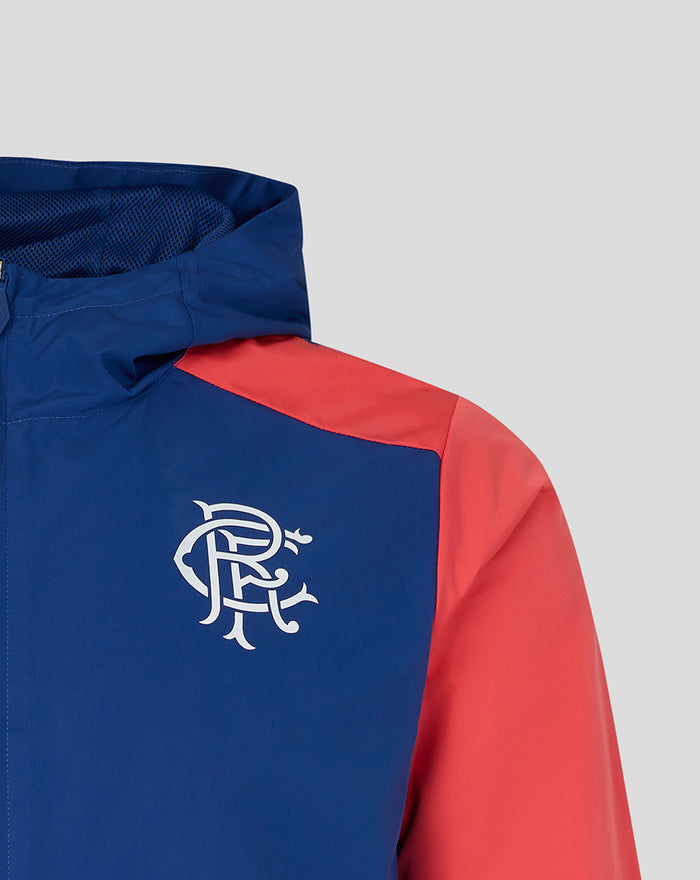 Rangers FC blue training jacket with a white crest on the chest and a red shoulder panel