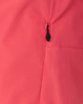Close up of coral Rangers FC training jacket fabric with a black zipper pull and seam line