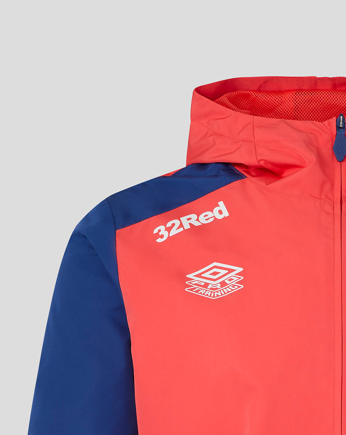 Close up of Rangers FC training jacket showing 32Red sponsor and Umbro logo on a coral torso with blue sleeves