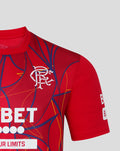 Rangers away goalkeeper shirt close up on red fabric with crest and Betway sponsor amid blue and yellow abstract lines.