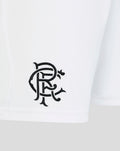 Close-up of white shorts showing the stitched Rangers crest near the hem