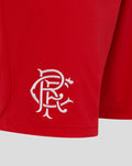 Close up of red shorts showing white embroidered Rangers crest near the hem