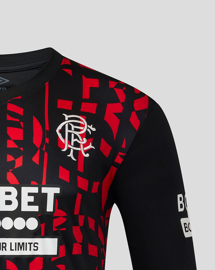 Close up of the Rangers jersey chest showing the Umbro logo and bold red graphic motif.