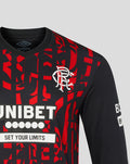 Close up of front of Rangers third pro long sleeve shirt shown with bold UNIBET sponsor and SET YOUR LIMITS slogan over a red patterned background.
