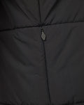 Close up of the zipper on a dark Rangers FC training gilet showing quilted fabric.