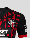 Close-up chest of Rangers women's third shirt with Umbro diamond logo on black red patterned fabric.