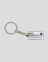 Street sign style keyring with a small white label attached to a metal chain.