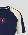 Front close up of navy Rangers tee with cream shoulder panel and red embroidered crest on the left chest.