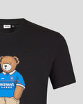 Close up of the black T shirt displaying the bear graphic on the chest wearing a blue polo.