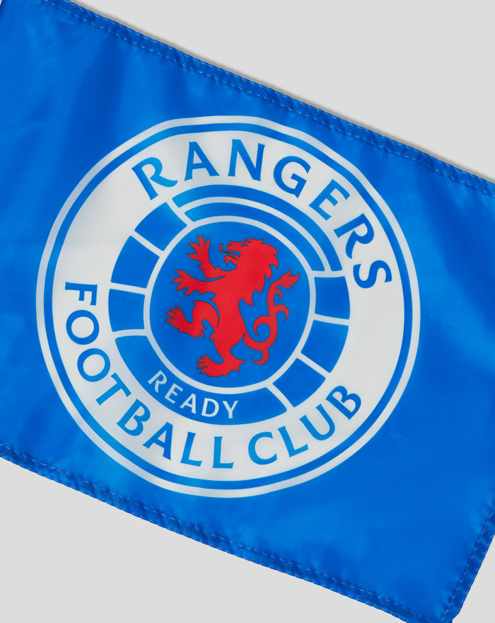Close up of a blue crest branded car flag showing stitching along the edge and the emblem