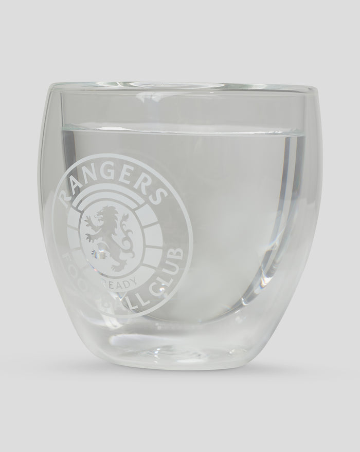 Close up of a double walled glass showing a water line and a faint Rangers crest on the side