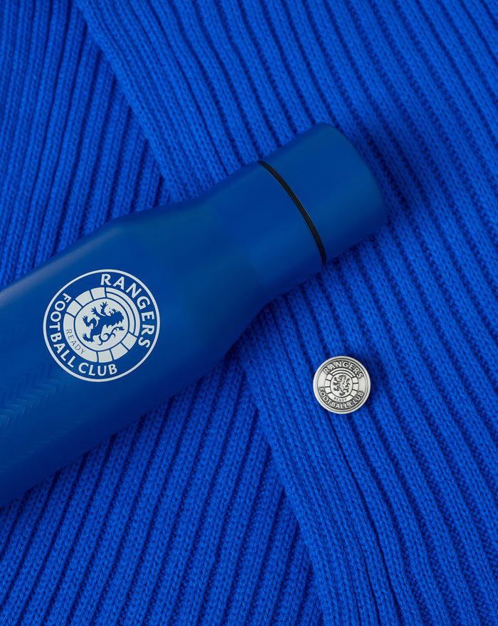 Blue bottle with Rangers Football Club crest resting on a blue knitted scarf background