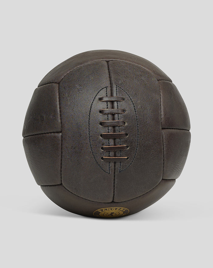 Close up side view of a dark brown deluxe leather football with lace detailing.