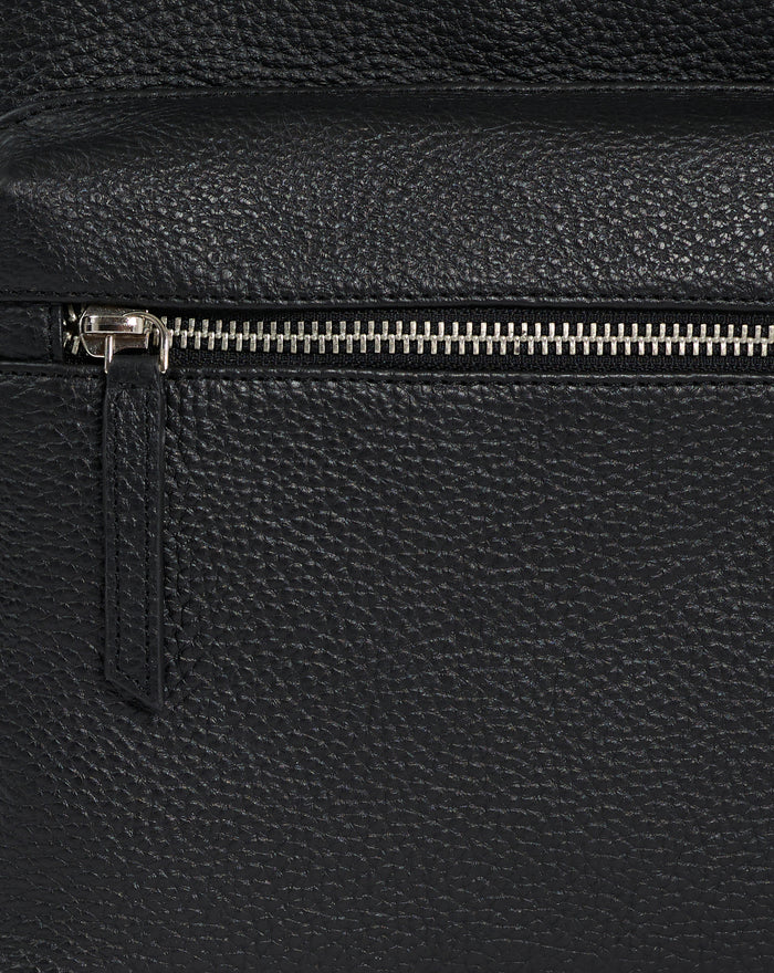 Close up of a metallic zipper on black pebbled leather Rangers Premium Leather Backpack