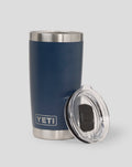Corp blue YETI 20oz tumbler close up with stainless steel rim and lid beside