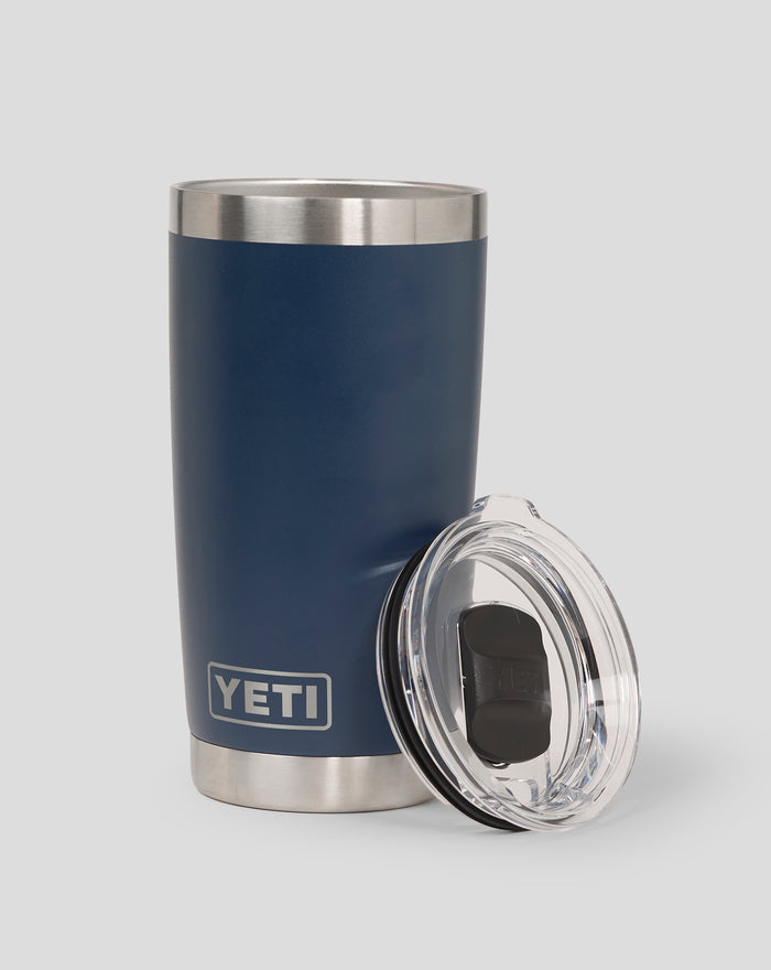 Corp blue YETI 20oz tumbler close up with stainless steel rim and lid beside