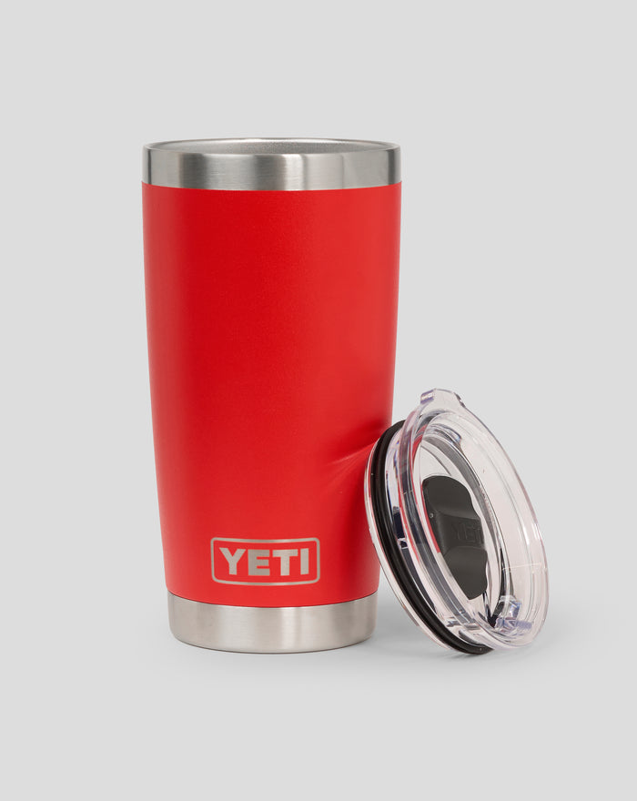 Corp red YETI 20oz tumbler with lid resting near the base and logo visible on the body