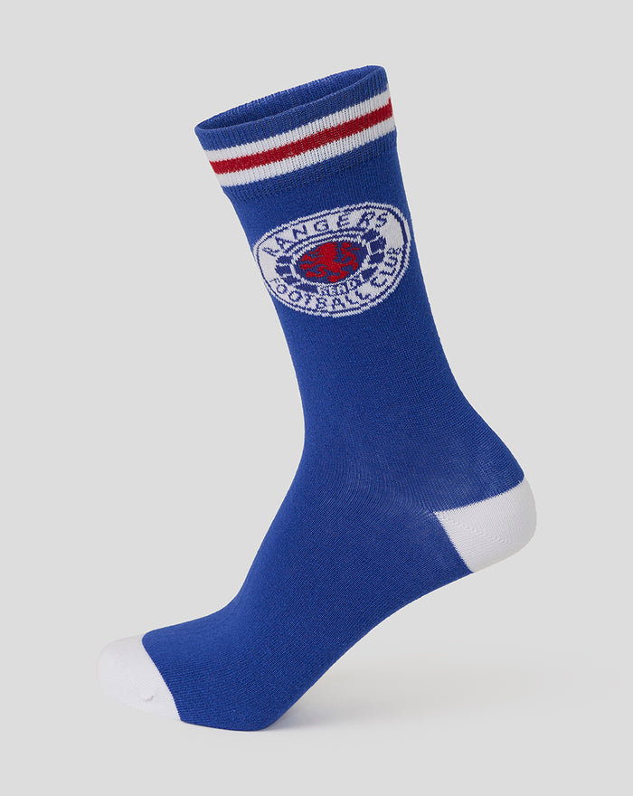 Unisex blue cotton crest socks with a red and white striped cuff and circular crest near the top