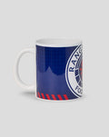 Angled view of Rangers FC large crest mug with navy blue background and partial crest visible