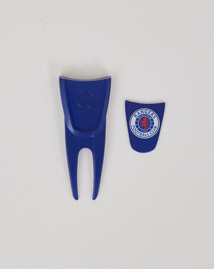 Blue plastic Rangers mission alignment tool with two forked prongs and a circular button, shown beside a blue shield with the Rangers crest