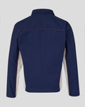 Back view of navy drill top showing red topstitching across the shoulders and beige side panels.
