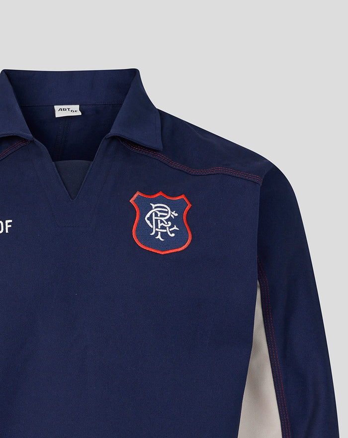 Navy drill top with red bordered crest patch on the left chest.