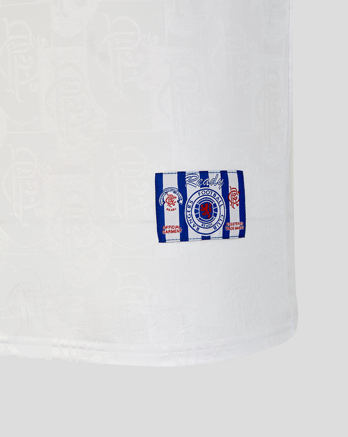 Close-up of the white Rangers away shirt hem showing a blue striped patch with the team crest