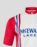 Rangers away shirt shoulder close-up showing red sleeve, red collar, and crest on white fabric with blue stripe accents.