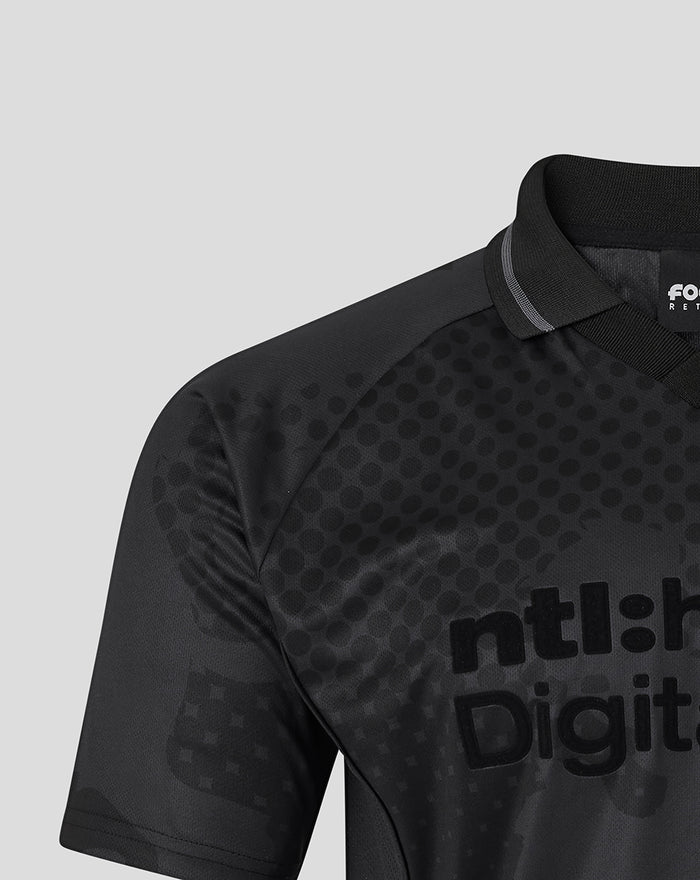 Close-up of the black blackout shirt showing a dotted pattern and large digital style lettering on the chest