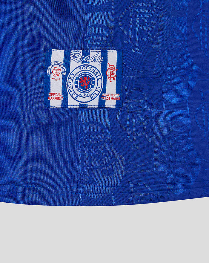 Blue retro home shirt fabric with a white striped patch badge featuring a red crest.
