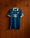 Blue Rangers FC 25/26 home shirt on a hanger with white collar and red trim, featuring Umbro logo, club crest and UNIBET sponsor on the front.