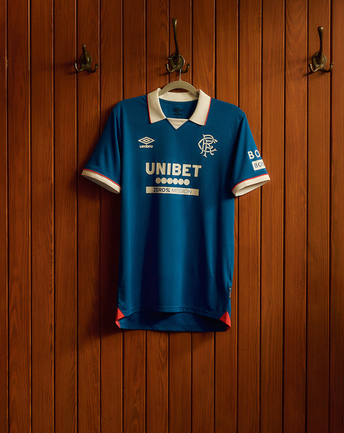 Blue Rangers FC 25/26 home shirt on a hanger with white collar and red trim, featuring Umbro logo, club crest and UNIBET sponsor on the front.