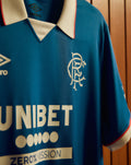 Rangers FC 25/26 home shirt close up blue fabric with Umbro logo on the chest club crest and UNIBET sponsor
