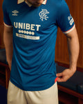 Rangers FC 25/26 home shirt on model front view with left chest crest and right chest Umbro logo