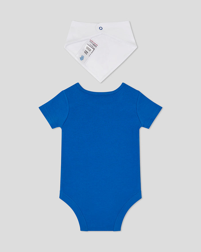 White bib with blue snap above a blue back view of the baby bodysuit from the CORE set