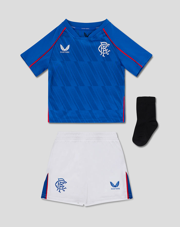 Rangers baby home kit blue shirt with geometric pattern and crest paired with white shorts and a black sock