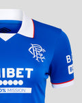 Close-up of Rangers 25/26 Home shirt collar and chest on blue fabric with white collar and red trim Umbro logo and crest.