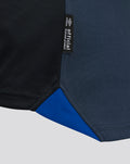 Close up of black official product tag attached to navy fabric of the Rangers third shirt.