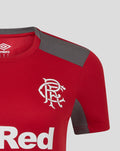 Close up of red women's training top shoulder with grey panel and team crest on chest