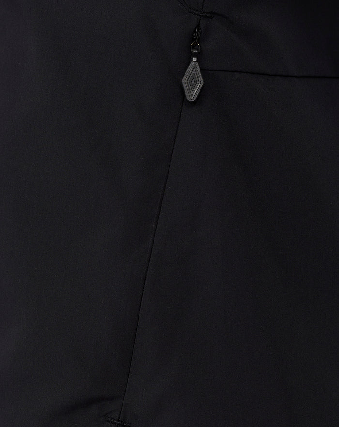 Zipper detail on a black hooded training jacket with a small diamond shaped zipper pull.
