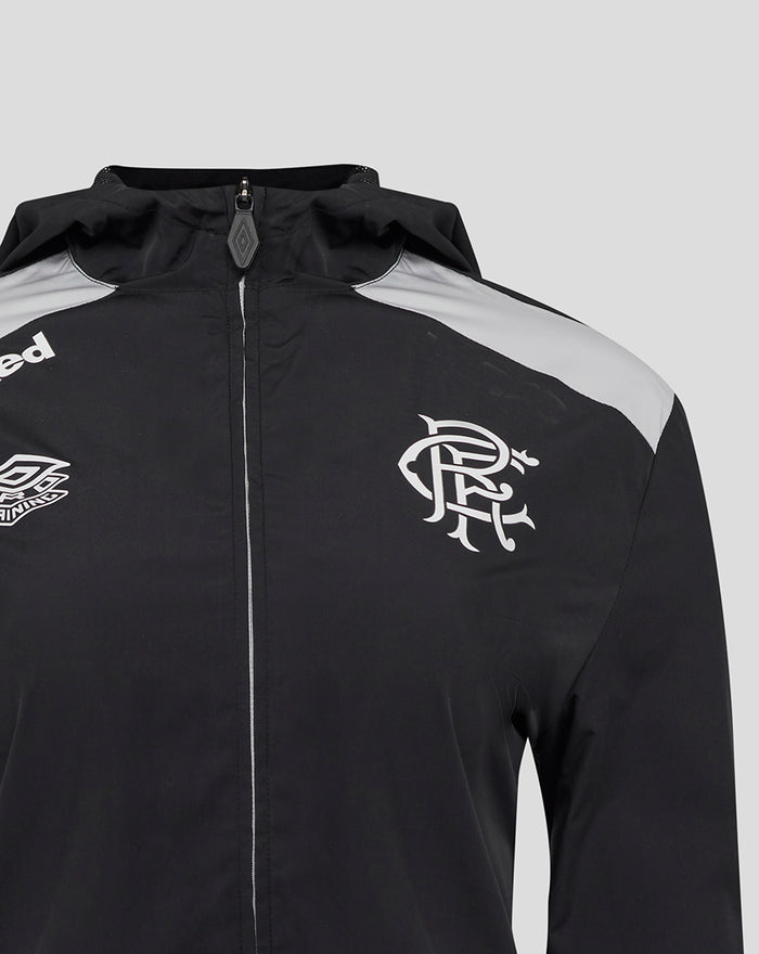 Close-up of front of black training hooded jacket with crest on chest and gray shoulder panels