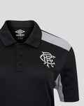Close up of black polo with grey shoulder panel and white club crest on chest