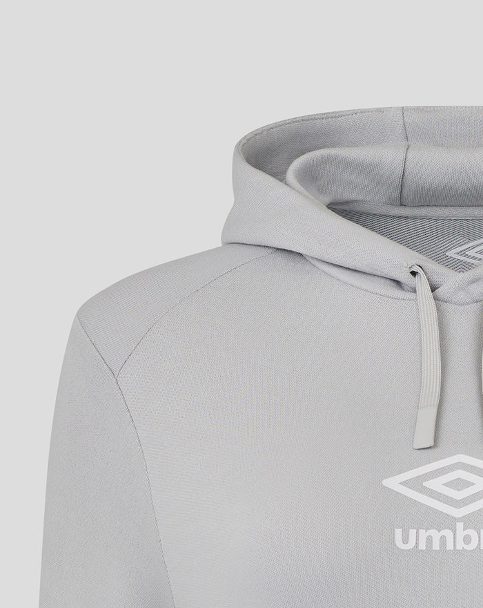 Close-up of the hooded sweatshirt neckline in light gray fabric showing drawstrings and part of the Umbro logo.