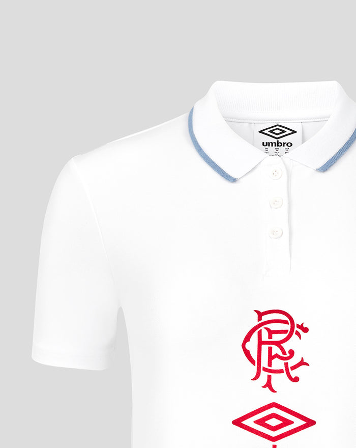 Close-up of white travel polo showing blue trimmed collar and red Rangers crest with Umbro logo on chest.