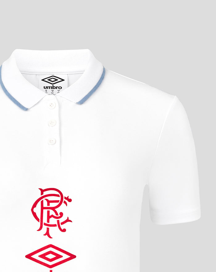 Front view of white travel short sleeve polo with blue edged collar, three button placket, and red Rangers crest with Umbro diamond.