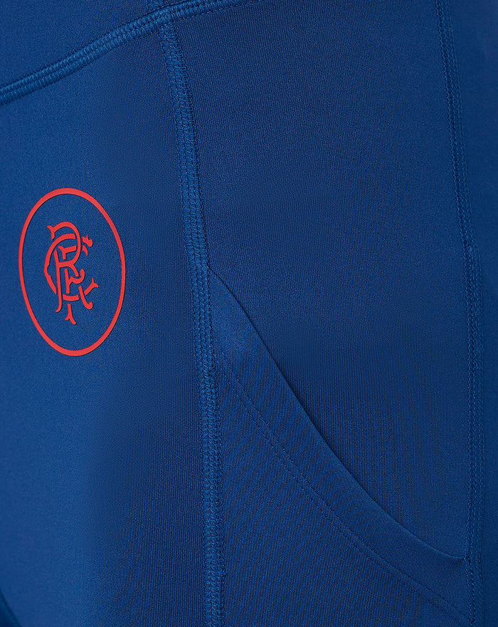 Close-up of navy leggings fabric with a red Rangers crest on the left leg
